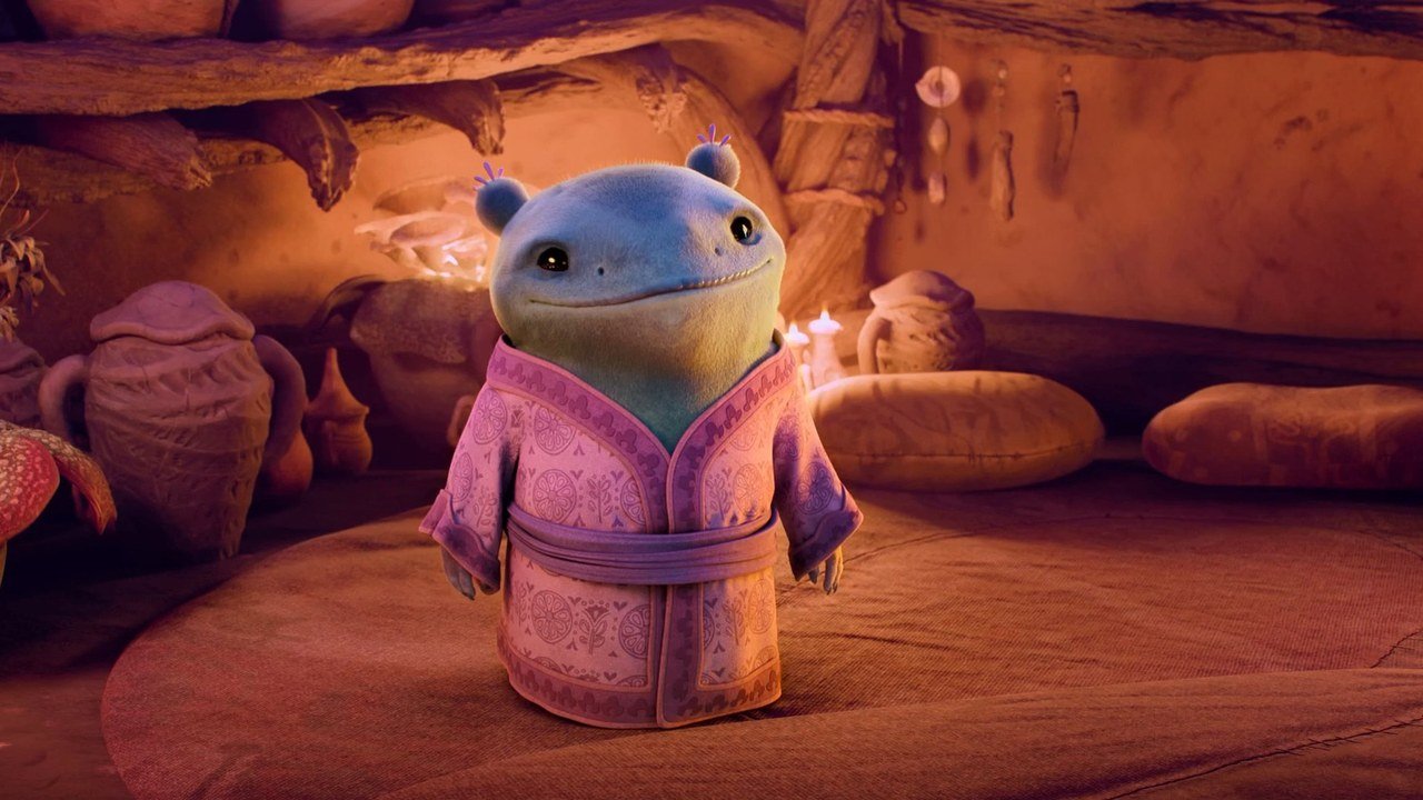 A small creature in a pink robe by candlelight